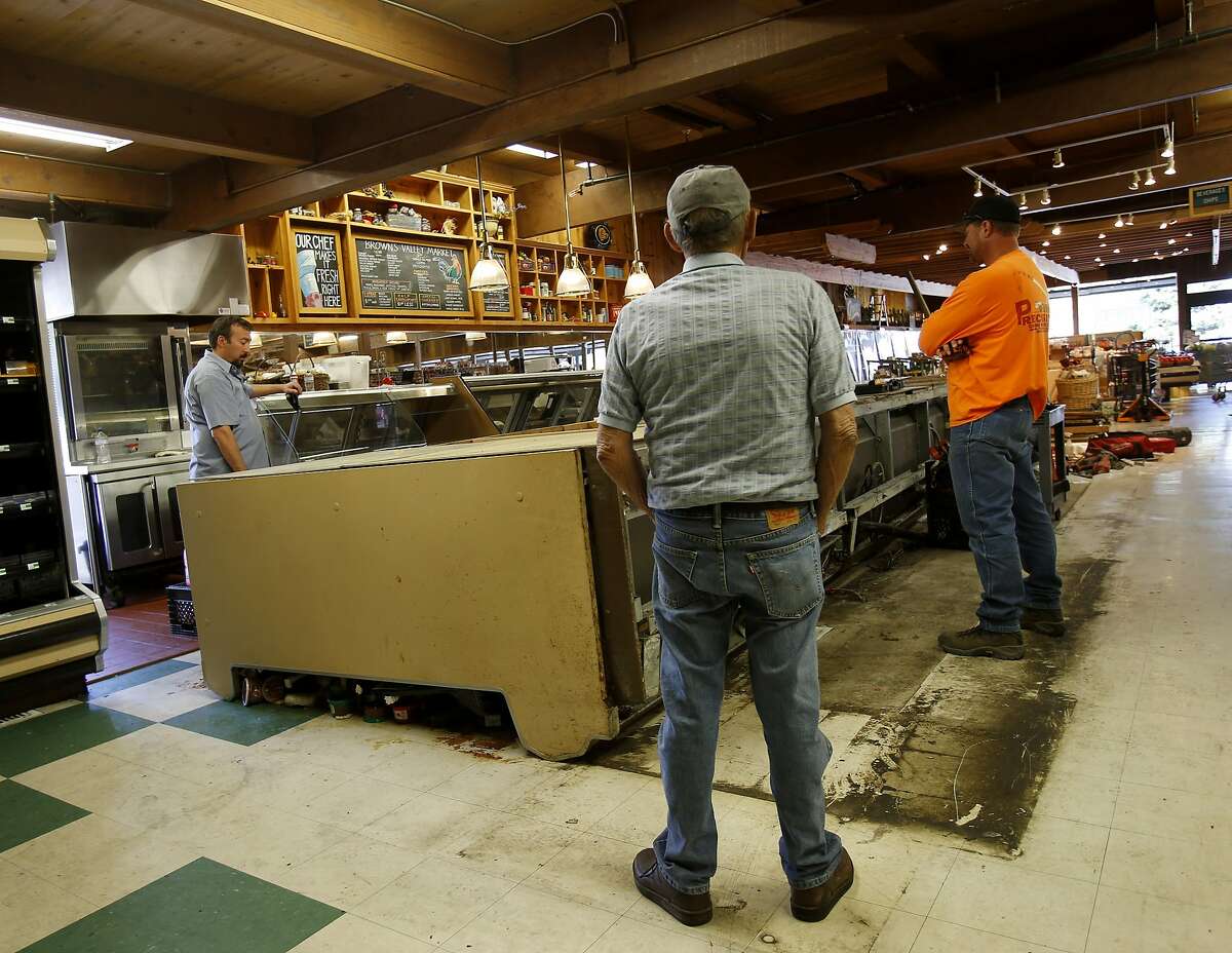 The workers at Browns Valley Market have to get a huge cooling display case upright before the business can reopen Tuesday August 26, 2014 in Napa, Calif. Risk Management Solutions (RMS) is a group of professionals that look at structural damage, liquefaction zones and interviews to determine the cost of the damage from an earthquake like the South Napa event.