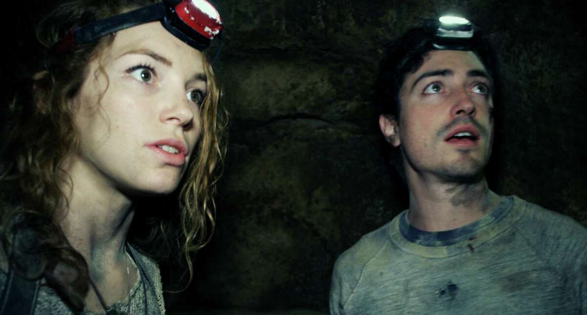 This image released by Universal Pictures shows Perdita Weeks, left, and Ben Feldman in a scene from the film, "As Above, So Below." (AP Photo/Universal Pictures)