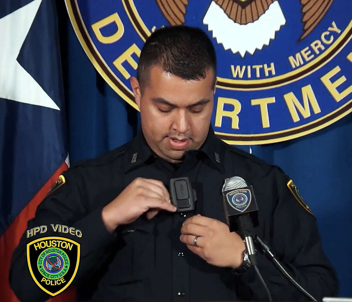 Jose Zapata of the North Patrol Division demonstrates a body camera - about the size of a pager - manufactured by Vievu.