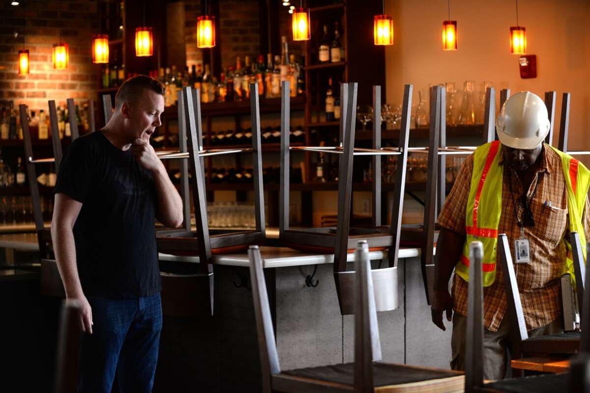 Tyler Rodde, left, owner of Oenotri restaurant in downtown Napa with City of Napa building inspector Keith Marks looking over some floor damage from the Sunday morning 6.0 quake. Rodde was relieved to be allowed to open up for dinner service that evening with the only restriction being no allowed outdoor seating. August 25, 2014.