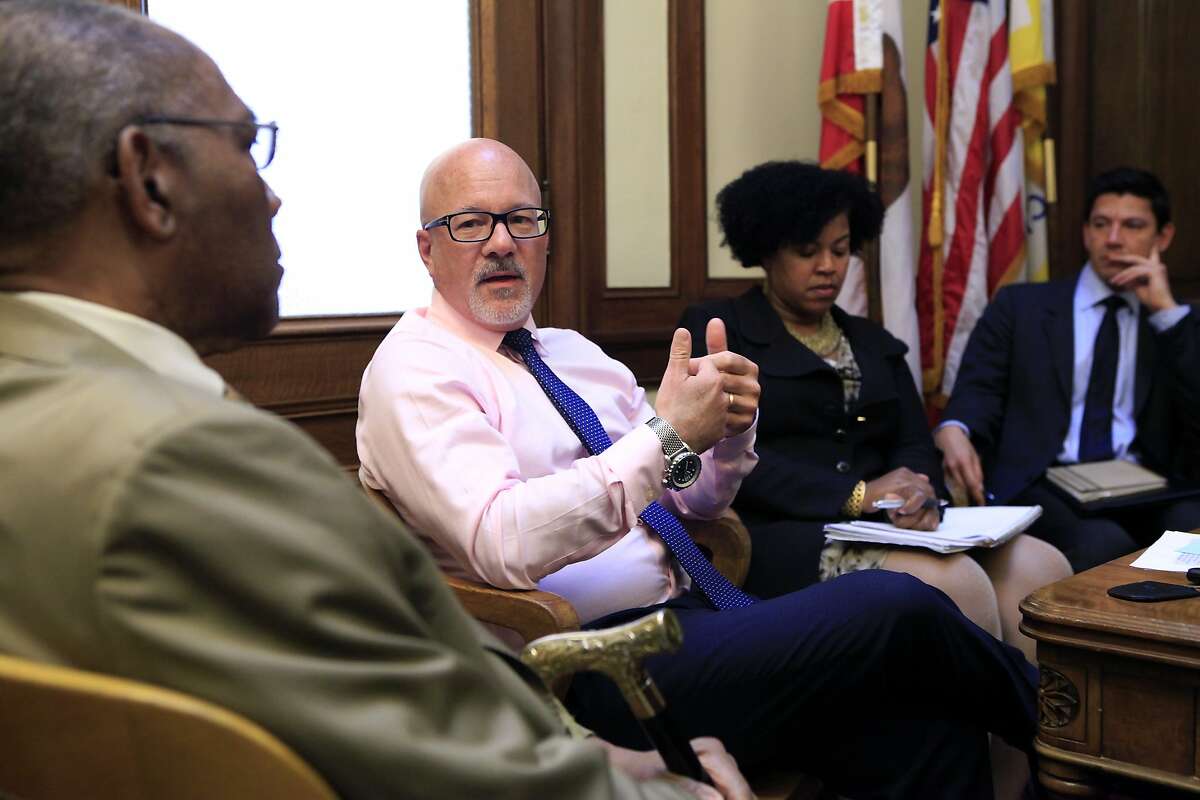 Steve Kawa, Chief of Staff to Mayor Ed Lee, center, speaks with Rev. Amos Brown of the NAACP and others during a meeting with African American community leaders on issues of housing and education, at City Hall in San Francisco, CA, Thursday, August 21, 2014.