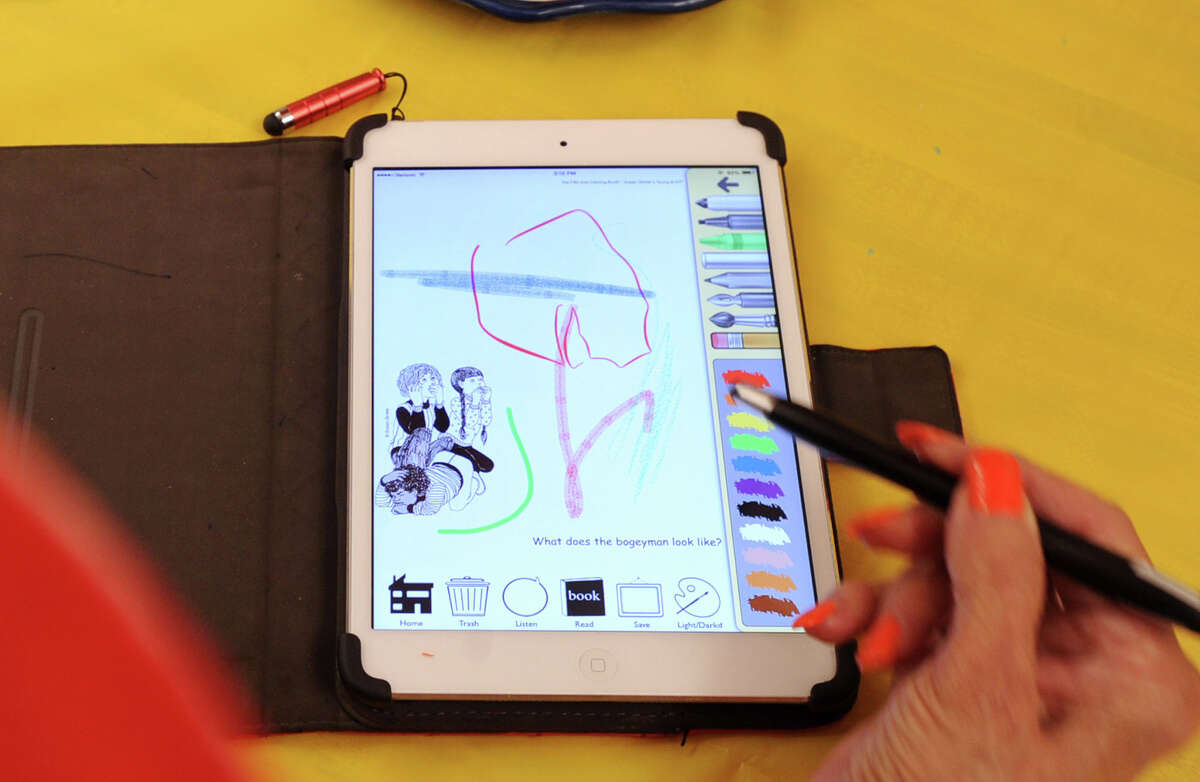 Art teacher Susan Striker displays her Anti-Coloring Book app on her iPad at the Cos Cob School where she teaches, Firday, Aug. 29, 2014. Striker said the app, that she created, encourages kids to take the creative lead with their art work.