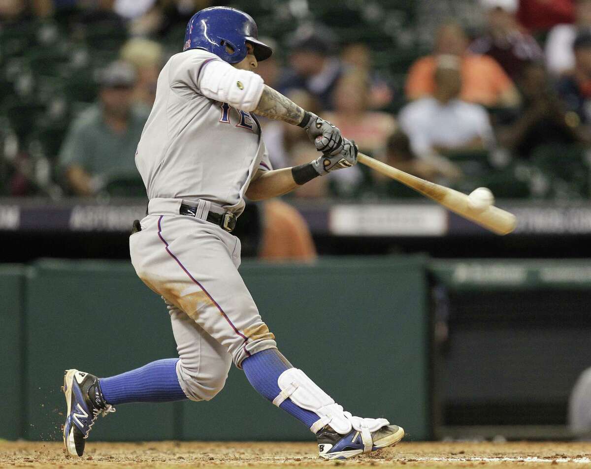 The Rangers' Rougned Odor connects for a three-run homer in the seventh inning of a blowout victory over the Astros on Friday at Minute Maid Park.