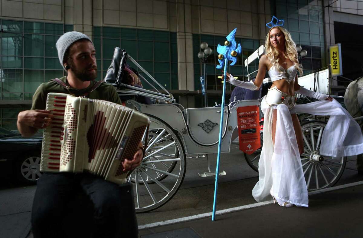 Janna Niki is dressed as Janna from League of Legends as Andrew Jamieson plays an accordion during the Penny Arcade Expo at the Washington State Convention Center. The event is expected to be attended by 85,000 gamers and will include concerts, game tournaments and previews of upcoming titles. Photographed on Friday, August 29, 2014.