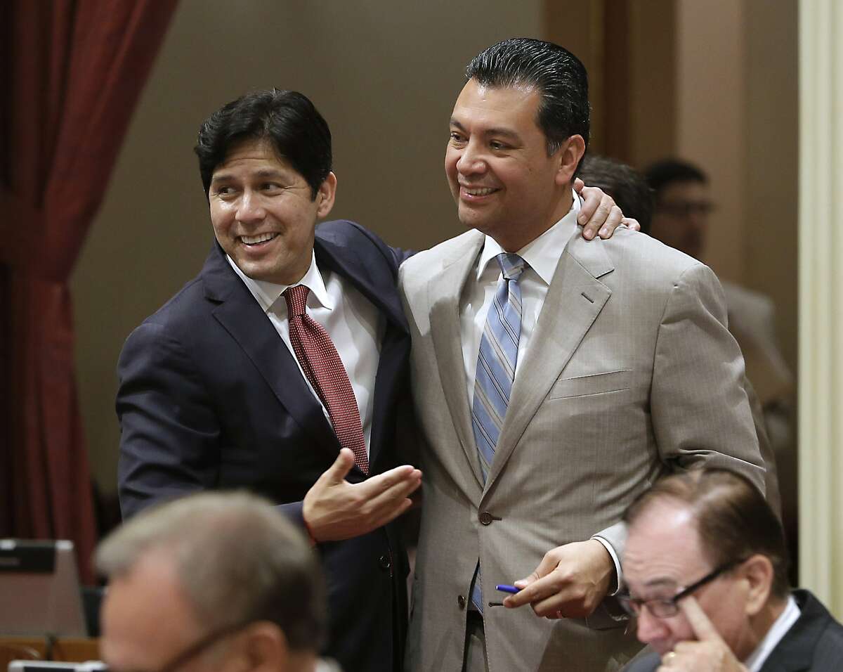 State Senators Kevin de Leon, D-Los Angeles, left, and Sen. Alex Padilla, D-Los Angeles, celebrate after lawmakers approved Padilla's bill to ban single-use plastic bags at the Capitol in Sacramento, Calif., Friday, Aug. 29, 2014. By a 22-15 vote, the Senate approved SB270 that makes California the first state to impose a statewide ban on single-use plastic bags. The bill now goes to Gov Jerry Brown. De Leon had previously opposed the bill, but gave his support after protections were added for plastic bag manufacturers.