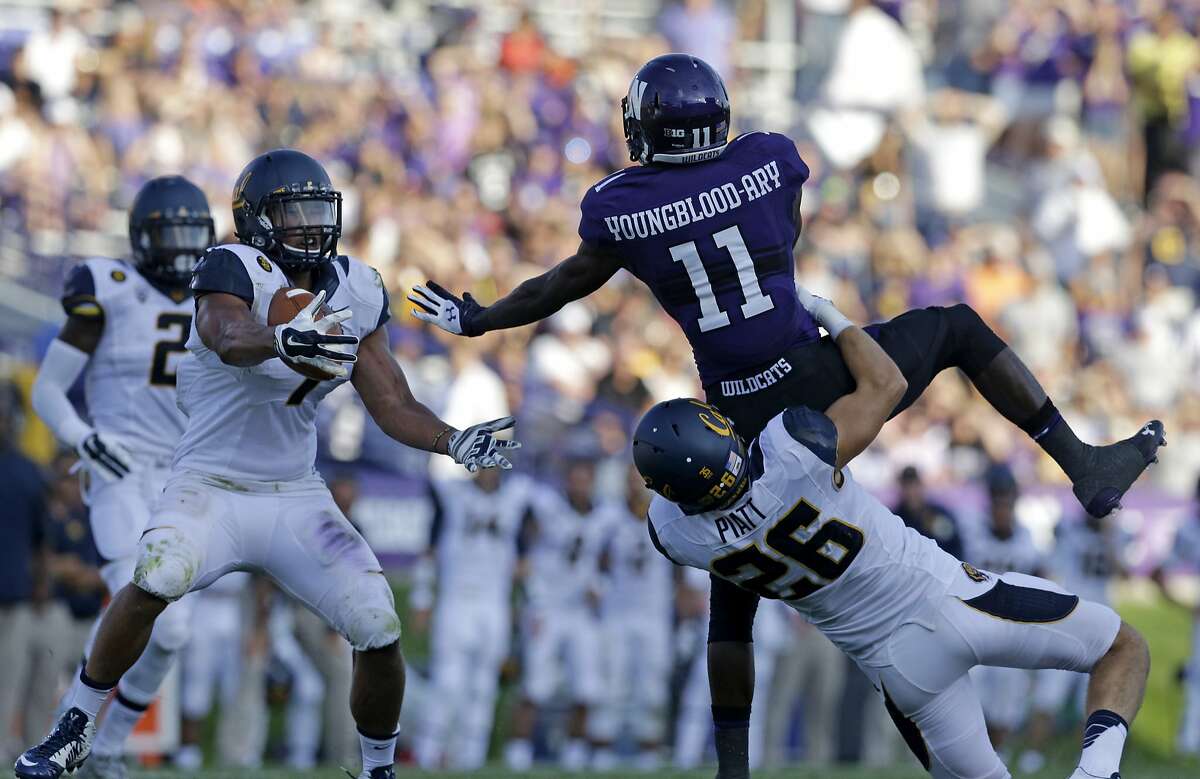 California linebacker Jalen Jefferson (7), left, intercepts the ball as safety Griffin Piatt (26) tackles Northwestern wide receiver Pierre Youngblood-Ary (11) during the second half of an NCAA college football game in Evanston, Ill., Saturday, Aug. 30, 2014. California won 31-24. (AP Photo/Nam Y. Huh)