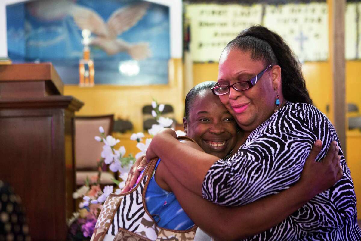 Tracy Chassion, right, receives a hug from her friend ﻿Shirley Harris-Swope﻿ at a prayer vigil in Houston Saturday. ﻿Chassion's 12-year-old daughter ﻿died two days after collapsing at an Alief school in 2010.