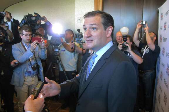 U.S. Sen. Ted Cruz, R-Texas, speaks to reporters after his speech at the Americans for Prosperity Summit in Dallas on Saturday, Aug. 30, 2014. He told the influential gathering of conservative activists Saturday that "we are part of a grassroots fire that is sweeping this country." (AP Photo/Will Weissert)