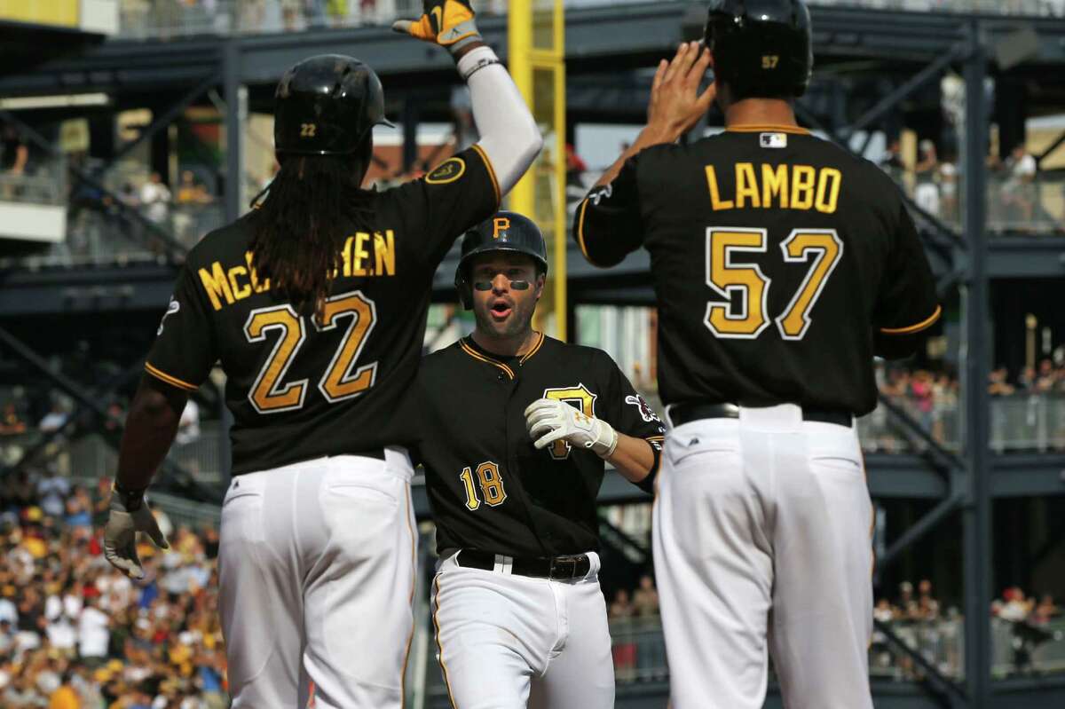 Andrew McCutchen (left) and Andrew Lambo greet Neil Walker after his three-run homer in the first.