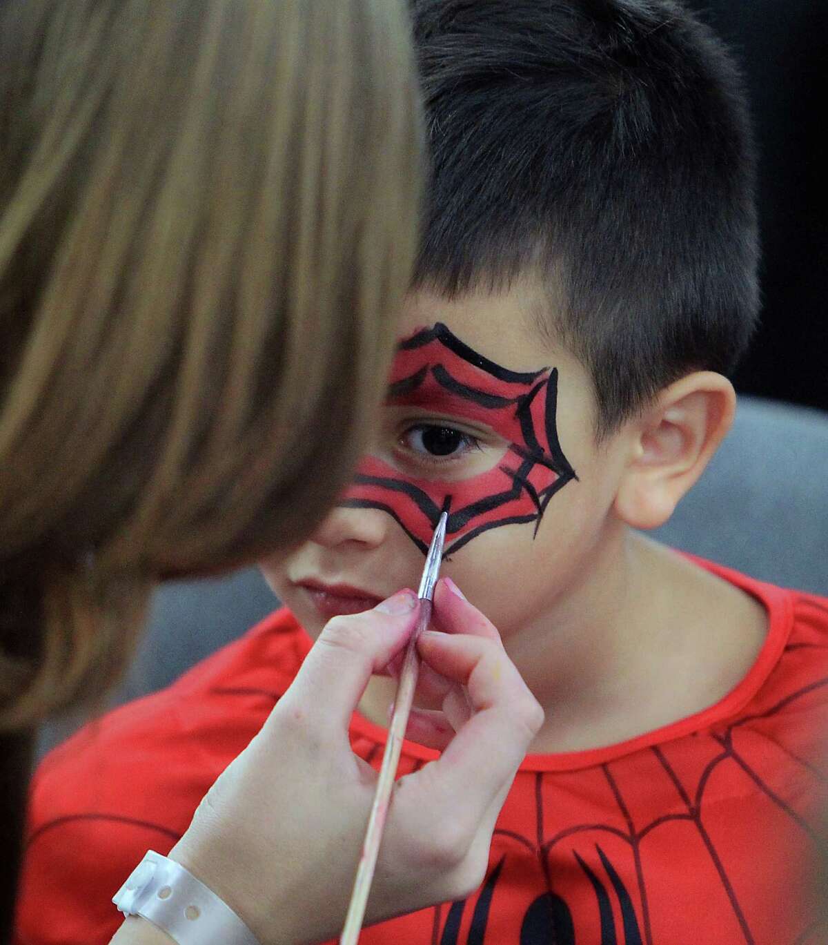 Four-year-old Michael Thornton has his face painted during the Amazing Houston Comic Con convention at George R Brown Convention Center Sunday, Aug. 31, 2014, in Houston.