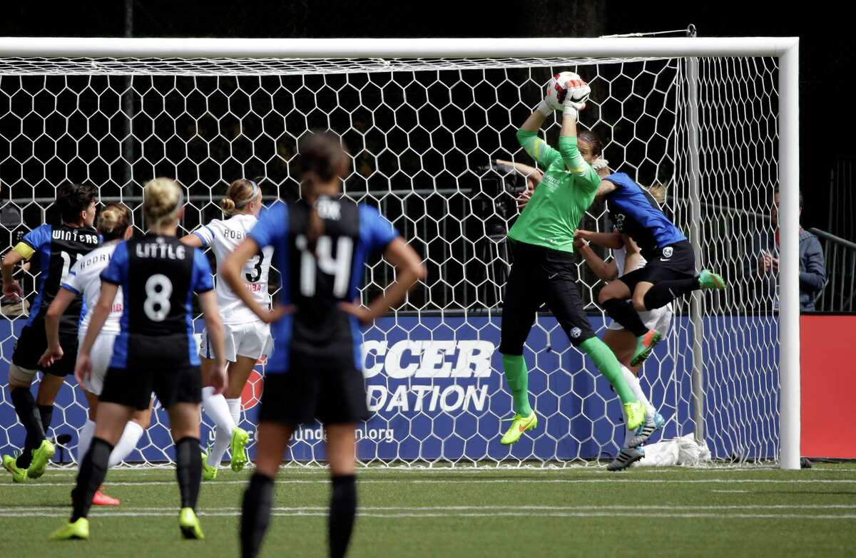 FC Kansas City goalie Sara Keane, makes a stop against the Seattle Reign FC in the second half of the NWSL championship soccer match Sunday, Aug. 31, 2014, in Tukwila, Wash. Kansas City won 2-1.