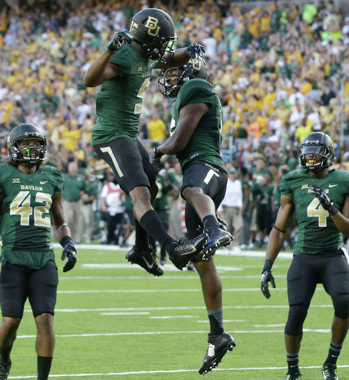 Baylor wide receiver KD Cannon (9) celebrates his touchdown catch with teammate Davion Hall (16) as Levi Norwood (42) and Jay Lee (4) look on during the first half of an NCAA college football game against SMU Sunday, Aug. 31, 2014, in Waco, Texas. (AP Photo/LM Otero)