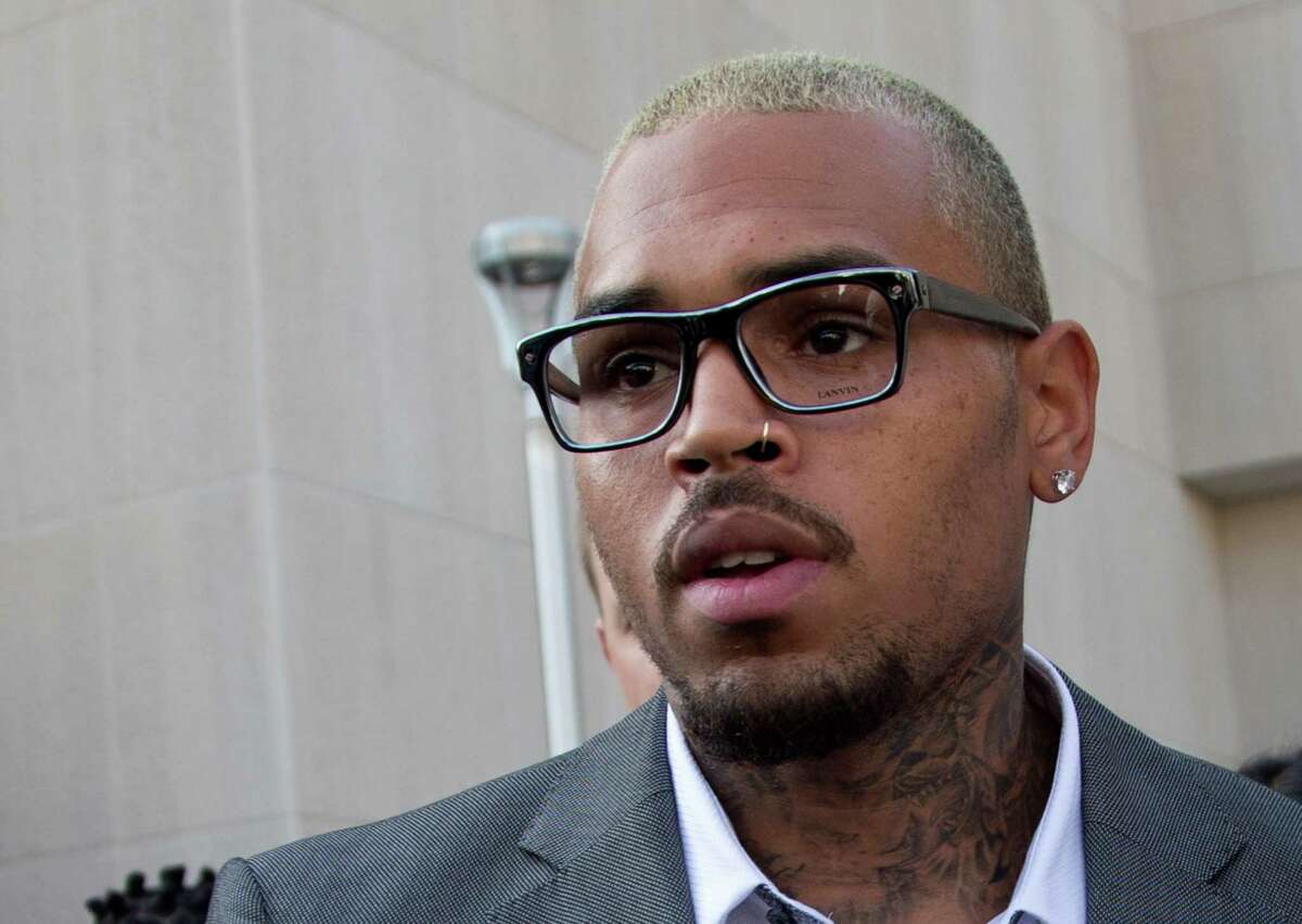 Singer Chris Brown leaves District of Columbia Superior Court in Washington, Tuesday, Sept. 2, 2014, after pleading guilty on a misdemeanor assault. Brown pleaded guilty on Tuesday to hitting a man outside a Washington hotel, an assault that occurred while the singer was on probation for attacking his then-girlfriend Rihanna. Brown pleaded guilty to misdemeanor assault and was sentenced to time served. He spent two days in a District of Columbia jail in this case. (AP Photo/Manuel Balce Ceneta) ORG XMIT: DCMC103