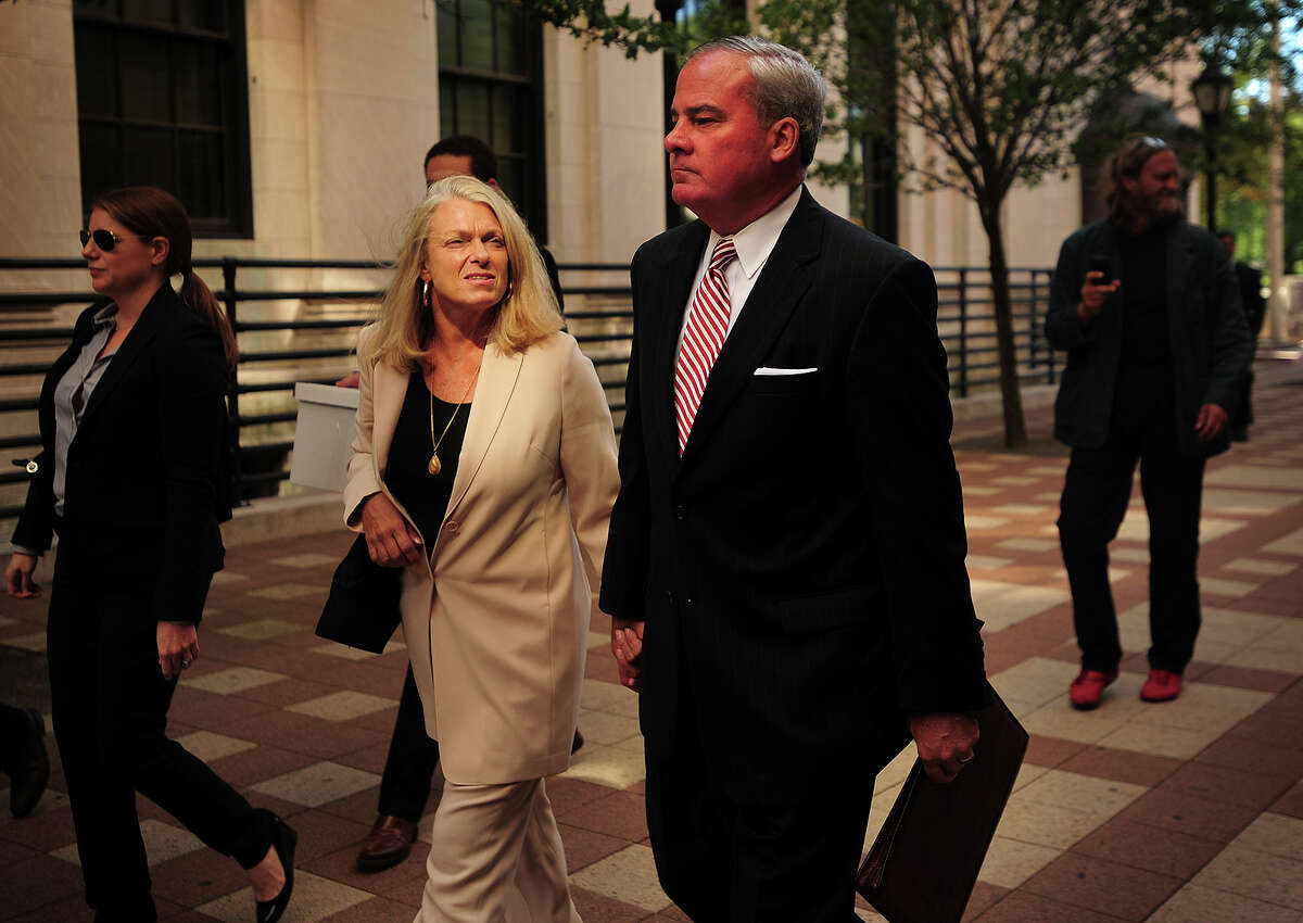 With wife Patty Rowland, left, former Governor John Rowland exits federal court in New Haven, Conn. on Wednesday, September 3, 2014. Rowland is on trial on seven charges including conspiracy and obstruction of justice.