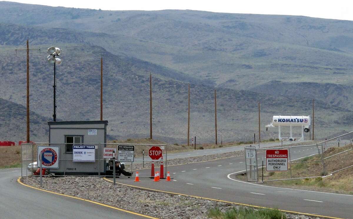 FILE - This Aug. 1, 2014 file photo shows security guards at the gate to the site Tahoe Reno Industrial Center about 15 miles east of Reno, Nevada. Tesla Motors has selected the site in Nevada for a massive, $5 billion factory that it will build to pump out batteries for a new generation of electric cars, a person familiar with the company's plans said Wednesday, Sept. 3, 2014. (AP Photo/Scott Sonner, File)