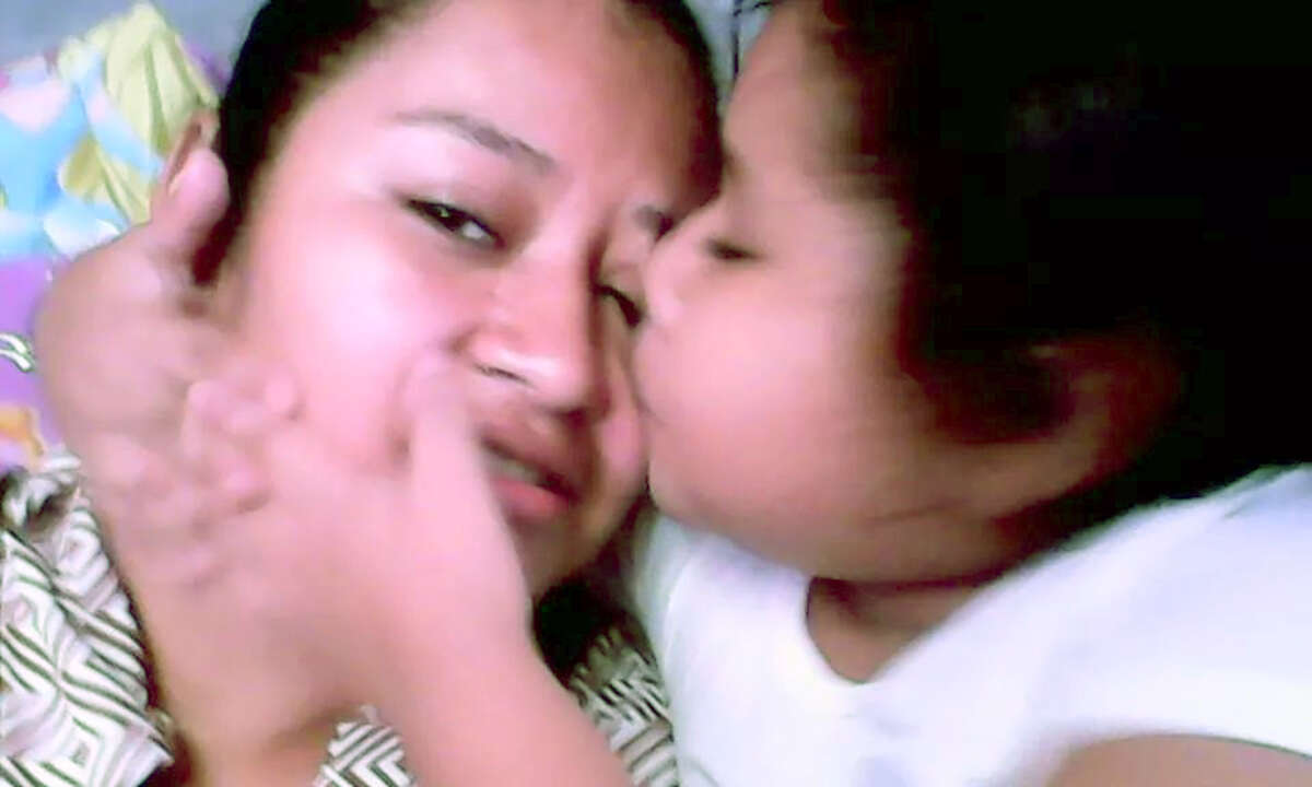 Nayely kisses her mother at the Karnes County Residential Center. The 7-year-old has a brain tumor and doctors recommend she get treatment now. Immigration authorities﻿ agreed Wednesday to release her for treatment.