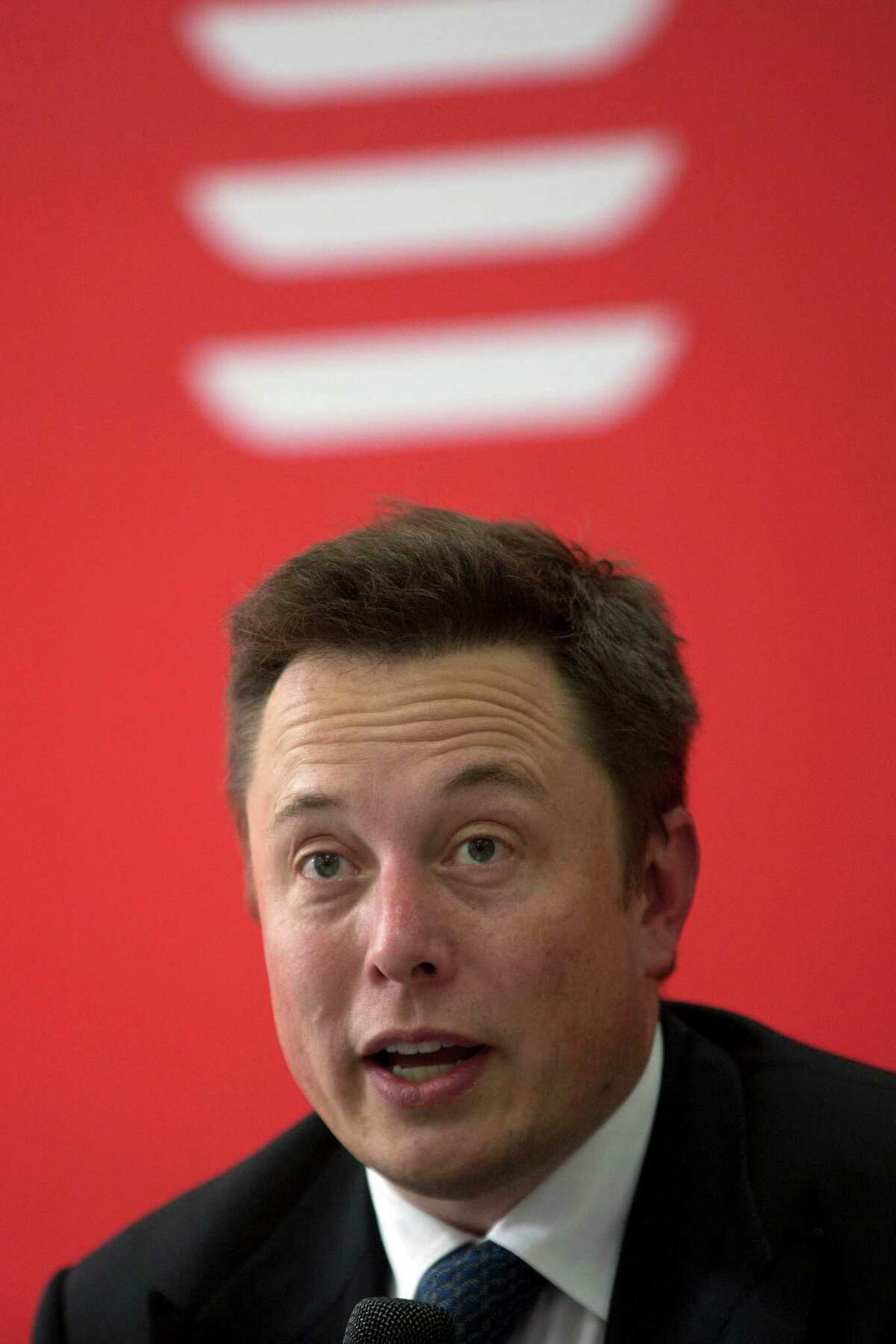 Tesla Motors Inc. CEO Elon Musk speaks before an event to deliver the first set of sedans to customers in Beijing, China, Tuesday, April 22, 2014. Tesla Motors delivered its first eight electric sedans to customers in China on Tuesday and Musk said the company will build a nationwide network of charging stations and service centers as fast as it can. (AP Photo/Ng Han Guan)