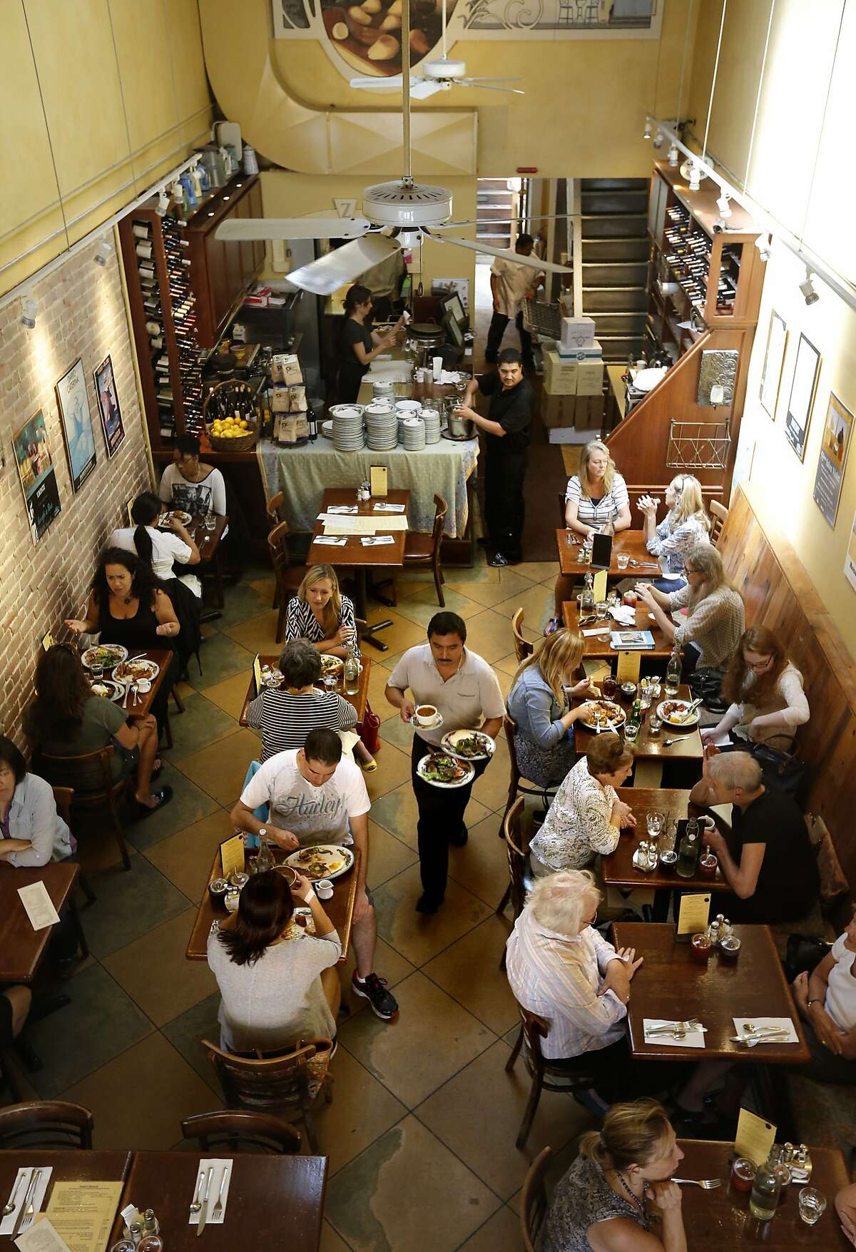 The lunchtime crowd being served at Zazie restaurant, in San Francisco, Calif., on Wednesday Aug. 27, 2014. Jen Piallat owner of Zazie offers her employees fixed schedules, full benefits and matching 401k plans and she says her business is more successful for it.
