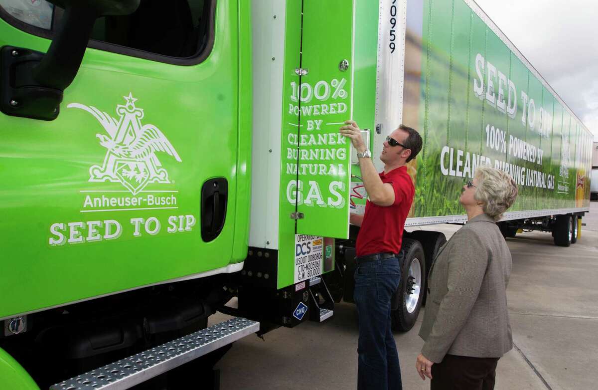 Chris Nordh shows Mayor Annise Parker a truck powered by compressed natural gas. A grant is helping to fund the Anheuser-Busch conversion.