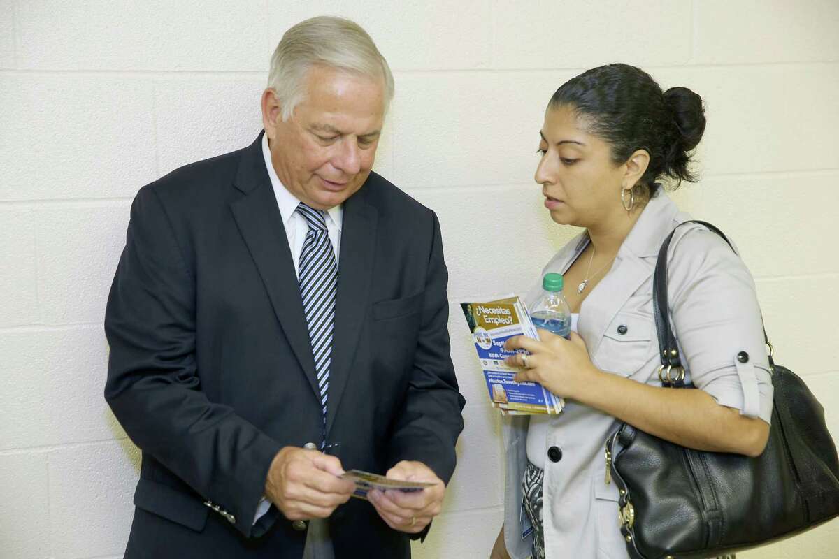 U.S. Rep. Gene Green speaks with Tanya Makany-Rivera, external affairs manager for the city of Houston, at a recent Town Hall meeting in Houston. As for not being Hispanic, Green says, "I don't think I'd get re-elected or elected if I wasn't doing the job."