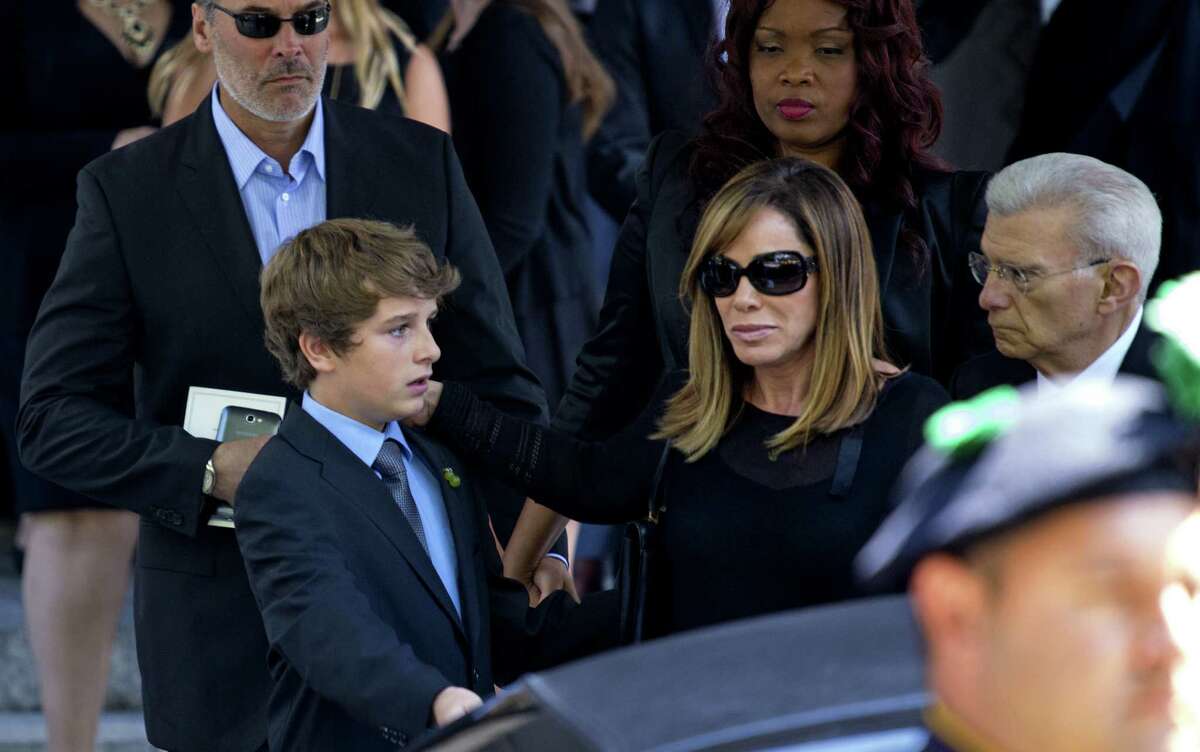 Melissa Rivers and her son Cooper Endicott walk to a waiting car after the funeral service for their mother/grandmother.