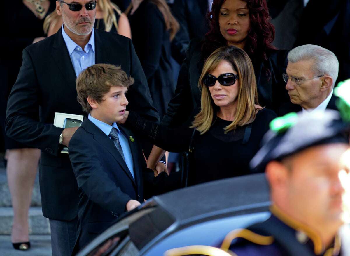 Melissa Rivers and her son Cooper Endicott walk to a waiting car after the funeral service for comedian Joan Rivers at Temple Emanu-El in New York Sunday, Sept. 7, 2014. Rivers died Thursday at 81. (AP Photo/Craig Ruttle)