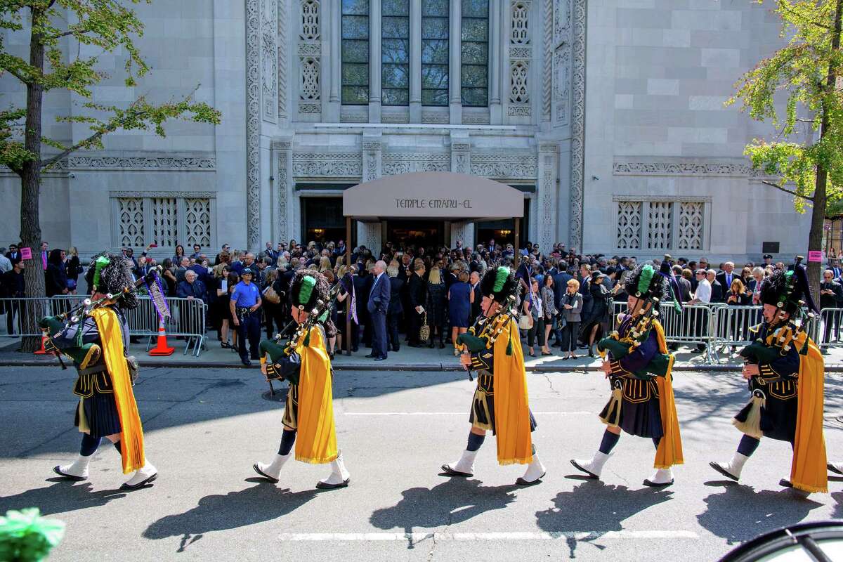 Bagpipers march from the funeral service for comedian Joan Rivers at Temple Emanu-El in New York Sunday, Sept. 7, 2014. Rivers died Thursday at 81. (AP Photo/Craig Ruttle)