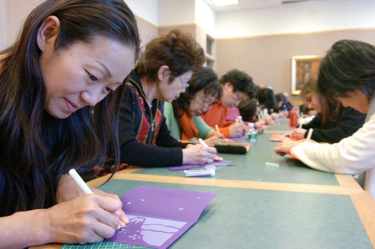 Artist Saori Kurioka takes advantage of a lesson in kirie, the traditional Japanese paper-cutting taught by renowned modern artist Shu Kubo Saturday afternoon Feb. 20, 2010 at the Greenwich Library. Using different colors and textures, Kubo cuts the paper on a rubber sheet with small knives and then layers it to create a multi-dimensional image. The event was presented by the Japan Society of Fairfield County.