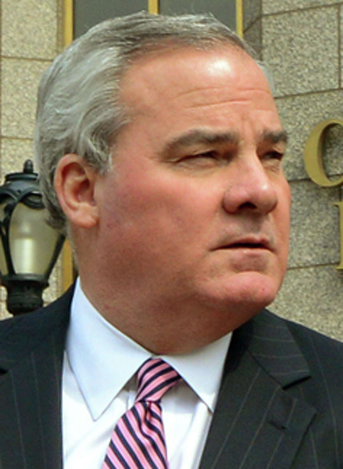 Former Connecticut Governor John Rowland leaves with his lawyer Kaitlin A. Halloran, Esq. outside the Connecticut Financial and Bank of America building in downtown New Haven, Conn. on Friday April 11, 2014. Earlier Rowland plead not guilty after being indicted at the federal courthouse next door.