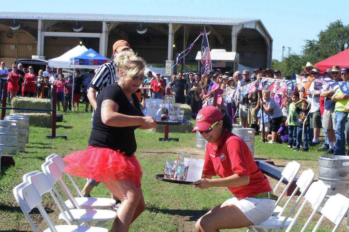Jessica Irwin (left), abartender at Tickets Sports Bar and Grill in Universal City, hops from seat to seat while her counterpart, Bush's Chicken employee Tia Racho from Schertz, does the same. The pair competed in an event during last year's Schertz Fest, which runs Sept. 18-21 at Pickrell Park.