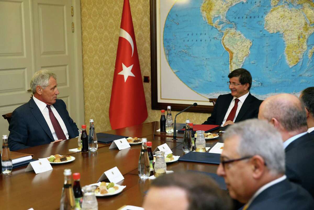 In this photo provided by the Turkish Prime Ministry Press Service, Turkish Prime Minister Ahmet Davutoglu, right, and U.S. Defense Secretary Chuck Hagel speak during a meeting in Ankara, Turkey, Monday, Sept. 8, 2014. Hagel is in Turkey for talks with Turkish leaders.(AP Photo/Hakan Goktepe, Turkish Prime Ministry)