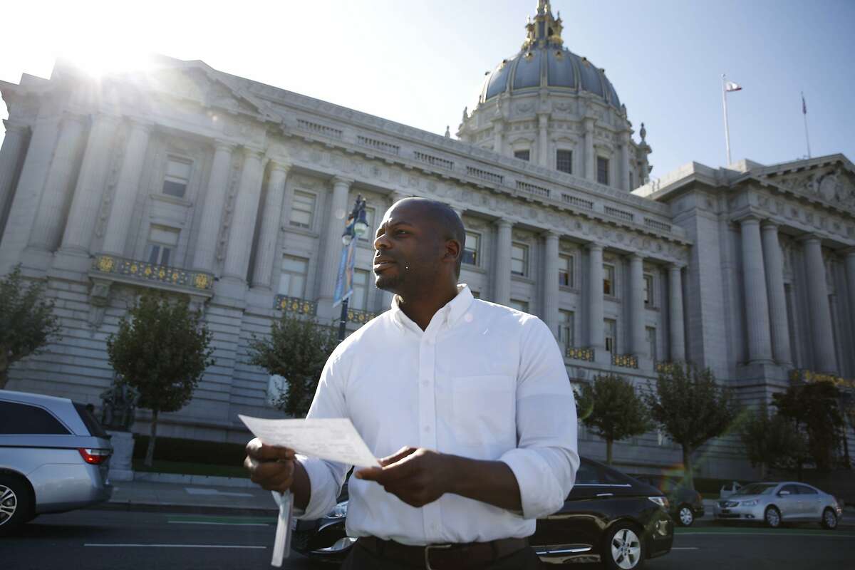 Mawuli Tugbenyoh, legislative aide with Supervisor Malia Cohen, holds a City Hall Vehicle Pool Trip Sheet as he locates the fleet vehicle he checked out at City Hall on Monday, September 8, 2014 in San Francisco, Calif.