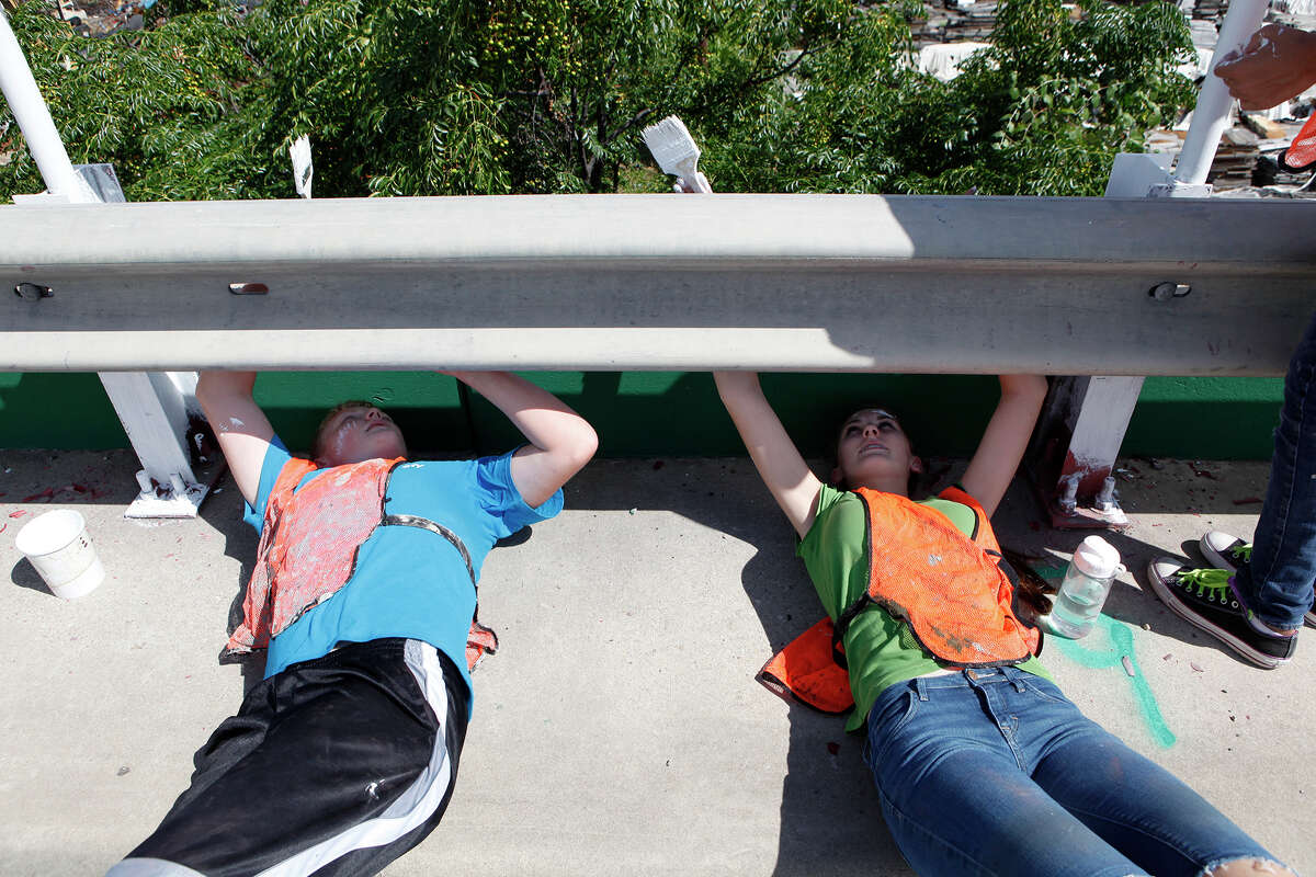 Nate Webb and Teresa Stevens are two of about 190 youth from 14 different congregations of the Church of Jesus Christ of Latter-day Saints who participate Sept. 6, 2014 in the "Graffiti Wipeout" on the Guadalupe Street bridge near S. Frio Street. All of the youth are part of the San Antonio West Stake and participated by sanding and painting the railing along the bridge as part of a service project for their church. Most of the youth are from San Antonio but some came from Uvalde, Hondo and Helotes to help out. The "Graffiti Wipeout" is a partnership between the city and several other local organizations to decrease vandalism.