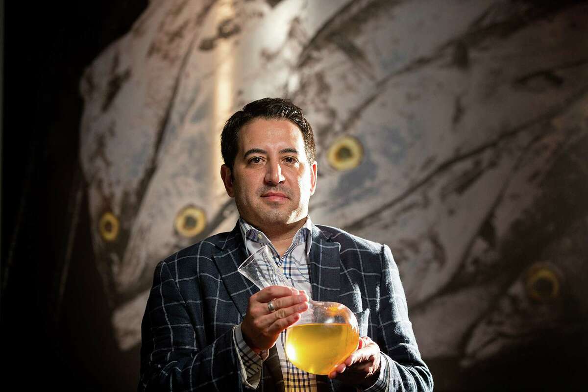 Rob Ortiz, manager and sommelier at Holley's Seafood, holds a decanter of Kalin Cellars Sonoma County Chardonnay, 1995, Thursday, Aug. 14, 2014, in Houston. ( Johnny Hanson / Houston Chronicle )