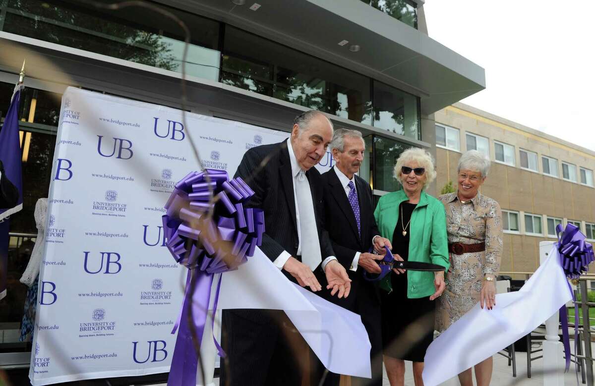 Trustee Frank Zullo, Ernest and Joan Trefz and Lt. Gov. Nancy Wyman cut the ribbon at the opening of the University of Bridgeport Ernest C. Trefz School of Business Tuesday, Sept. 9, 2014, in Bridgeport, Conn.