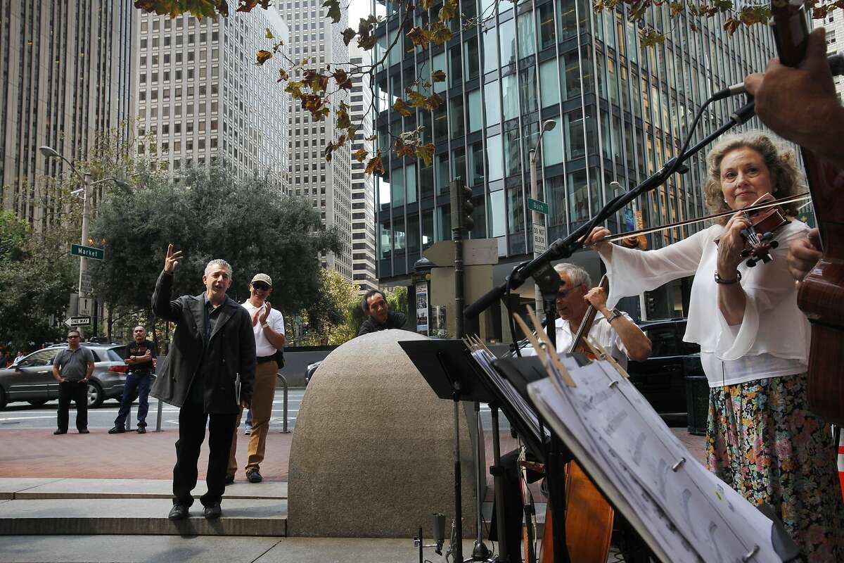 Tony Barbas, left, a songwriter and instrumentalist, sings along to live music as it is performed by from left, Steve Hanson, Harriet Newhart and Manuel Costancio of Dos Gardenias at the recently refinished Mechanics Plaza Sept. 9, 2014 in San Francisco, Calif. Tables and chairs were added to the space as well as a large checkers/chess board design on the ground. The band Dos Gardenias played music at noon as part of the People in the Plazas Summer Music Festival.