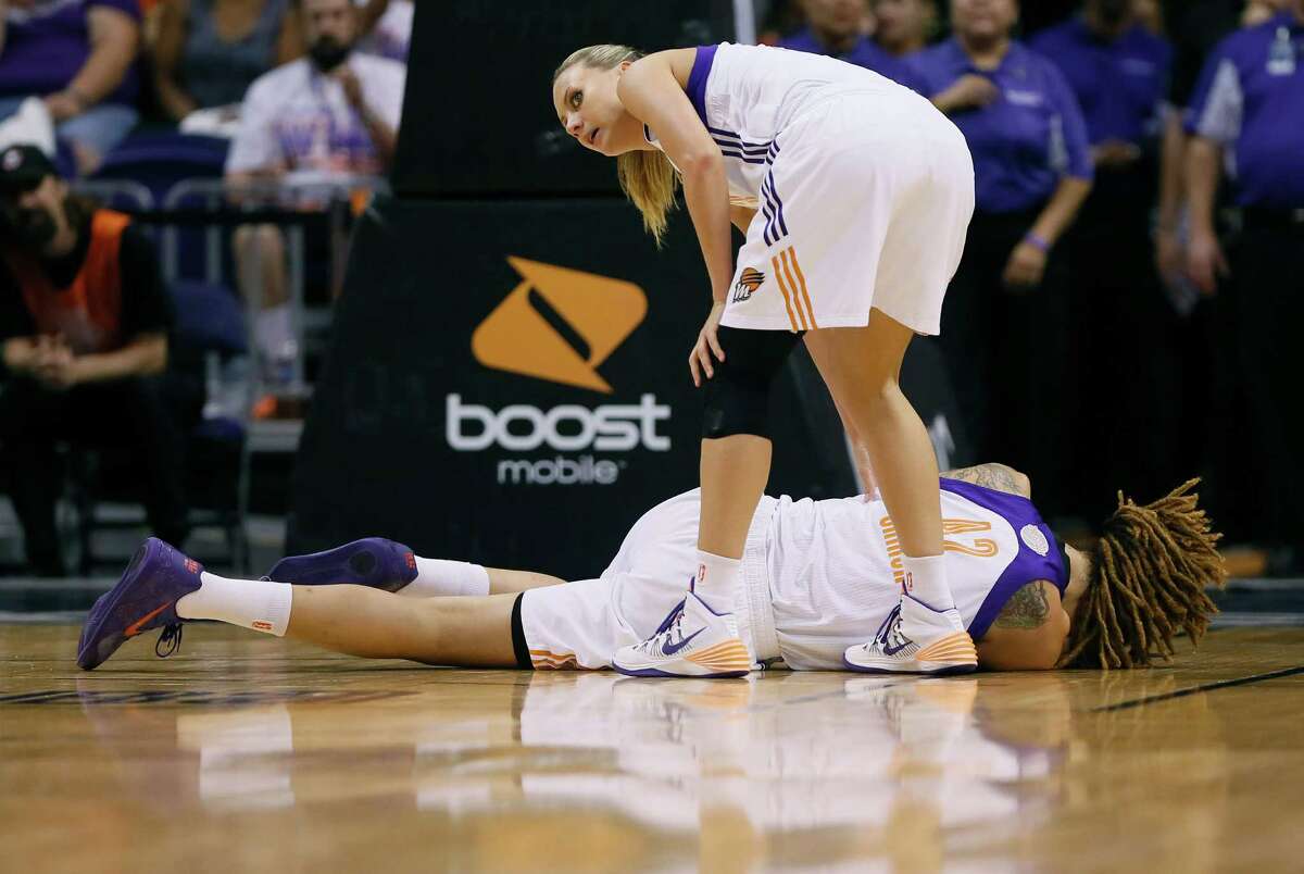 Phoenix's Penny Taylor asks for help after Mercury center Brittney Griner was felled by a cut above her eye during Game 2 of the WNBA Finals on Tuesday night.