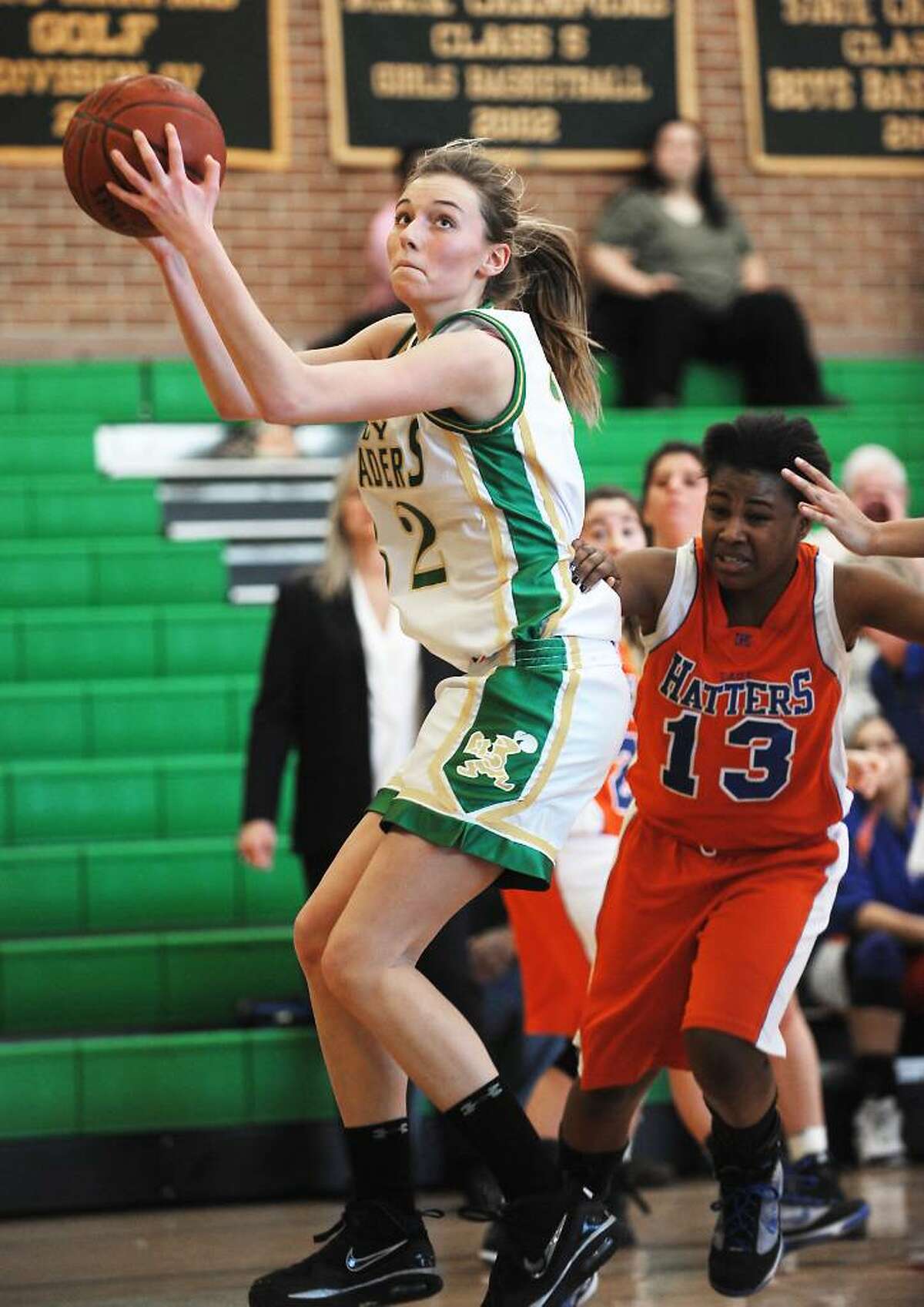 Trinity Catholic's Cayleigh Griffin goes in for a shot against Danbury's Jasmine Holmes in the quarterfinals of the FCIAC girls basketball championship in Stamford, Conn. on Saturday, Feb. 20, 2010.