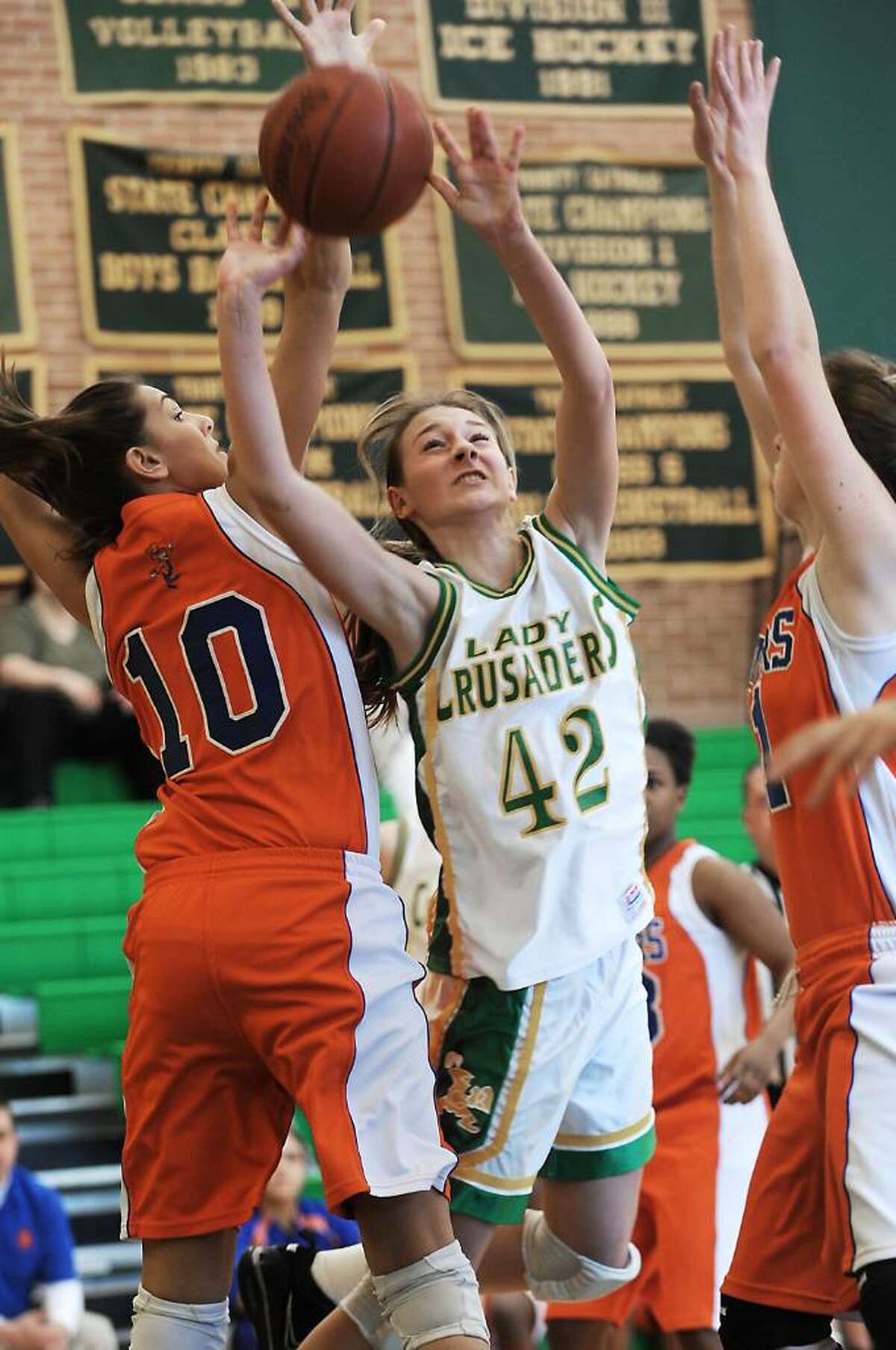 Trinity Catholic's Mackenzie Griffin goes up for a shot against Danbury's Casey Smith in the quarterfinals of the FCIAC girls basketball championship in Stamford, Conn. on Saturday, Feb. 20, 2010.