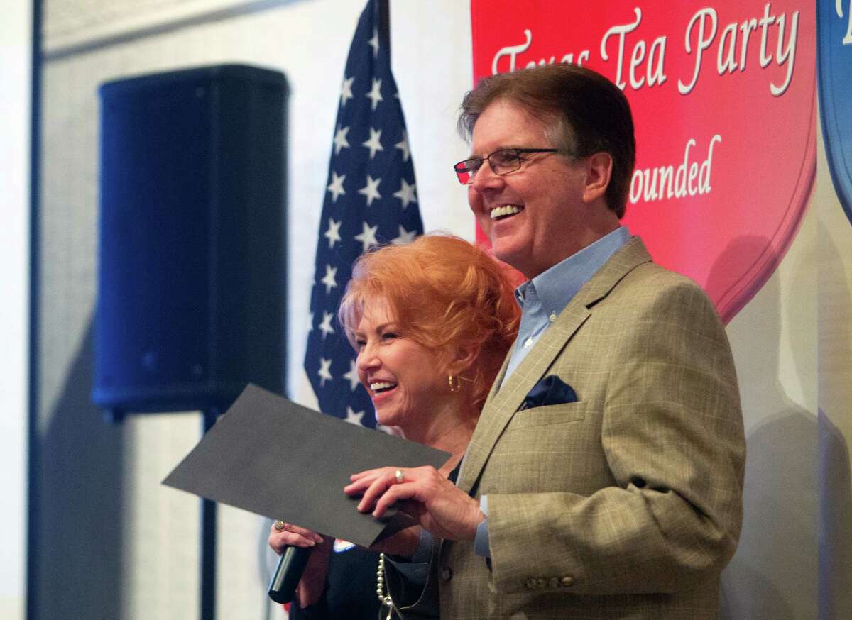 Senator Dan Patrick, right, and Kay Smith, left, smile after giving Patrick a donation for his campaign during a Tea Party Republican Women meeting at the Greenwood Forest Residents Club, Tuesday, Sept. 9, 2014, in Houston.