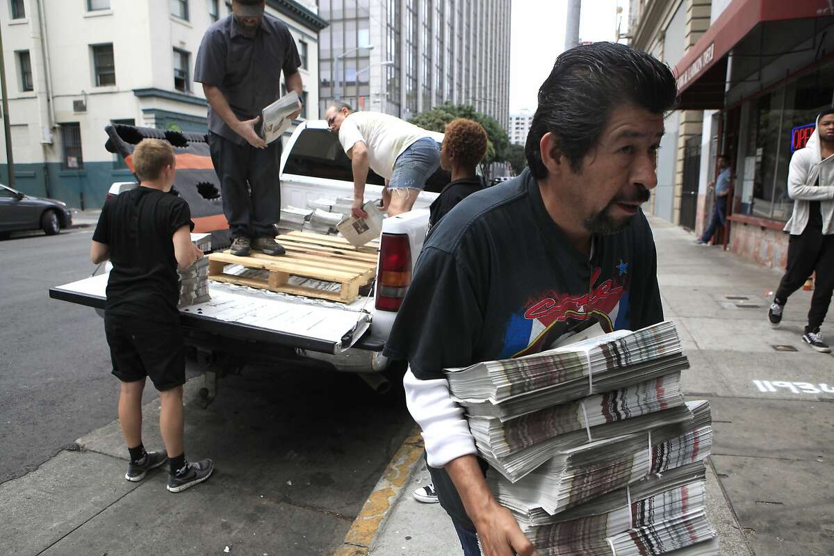 Housing Justice Director for the Coalition on Homelessness Miguel Carrera carries a stack of new Street Sheets into their headquarters in San Francisco, CA, Friday, August 29, 2014.