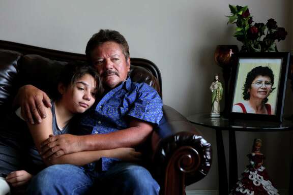*** LISE OLSON STORY TO BE PUBLISHED IN SEPTEMBER ***  Guillermo Gomez, husband of Vilma Marenco, embraces daughter, Lupita Gomez, in their home in northeast Houston.  Guillermo called his wife over 25 times and was waiting for her to come home to say goodbye before heading out to a work trip to New Orleans on July 15, 2014, in Houston, Tx. Vilma Marenco was driving home after her lunch shift at Papasitos, when an oilfield hauling truck loaded with heavy pipe ran a red light and crushed the passenger side of the Chevy Cavalier Vilma Marenco was driving. The driver had no insurance.