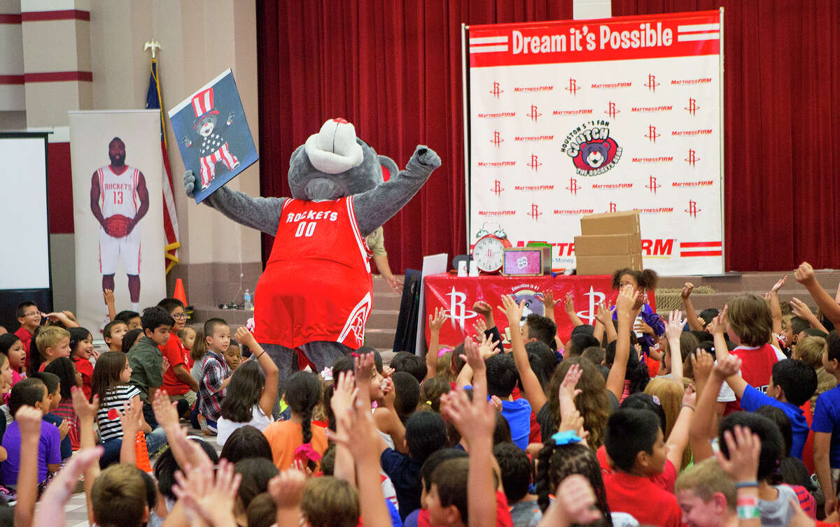Houston Rockets' mascot, Clutch, shows Gleason Elementary School students a picture of Clutch dressed as the president to remind students they can be whatever they want when they grow up, Wednesday, Sept. 10, 2014, in Houston.
