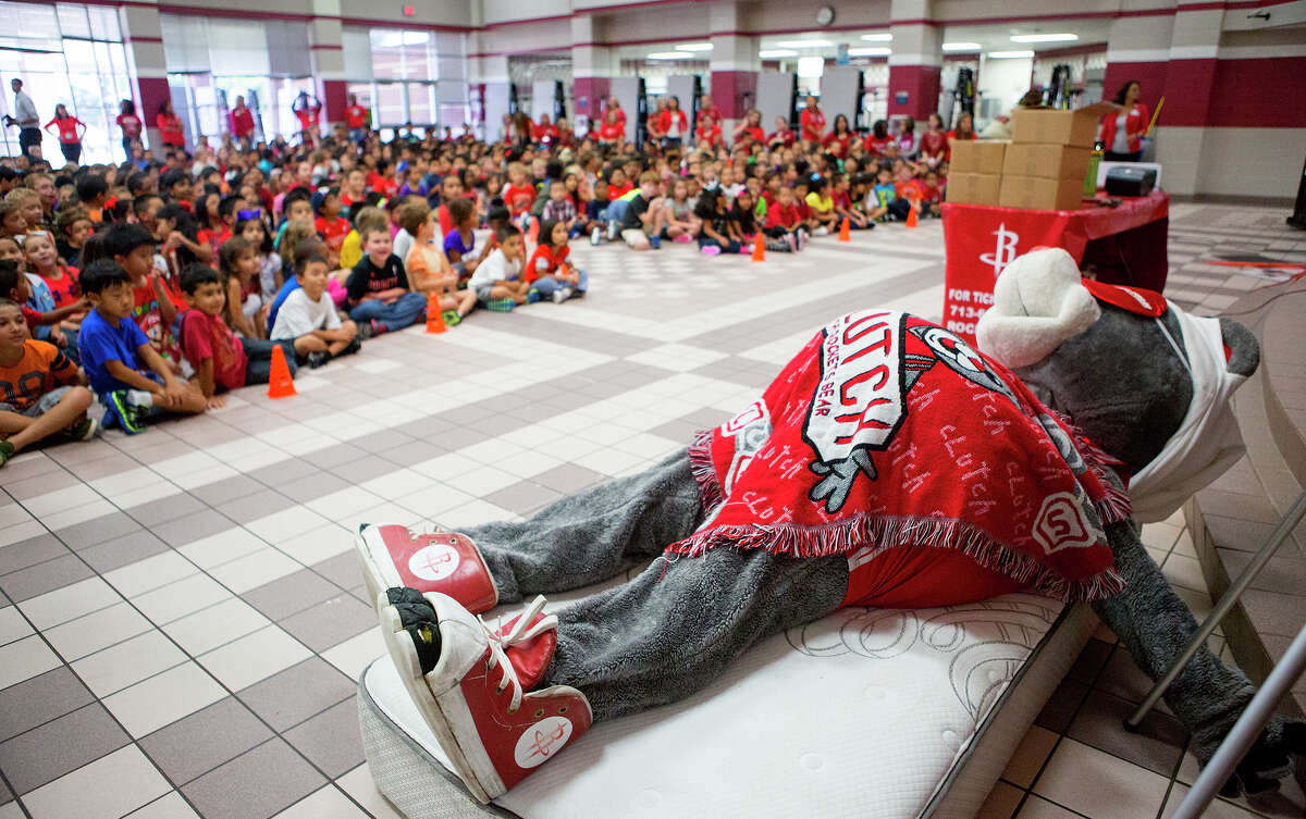 Gleason Elementary School students watch as the Houston Rockets' mascot, Clutch, takes a nap during a visit to the school, Wednesday, Sept. 10, 2014, in Houston. The visit was part of the "Good Night Sleep Show" tour in an effort to teach children about the importance of a good night's sleep for their education and health. The tour stresses the importance of getting 10 to 12 hours of sleep per night because rest helps with focus and learning.