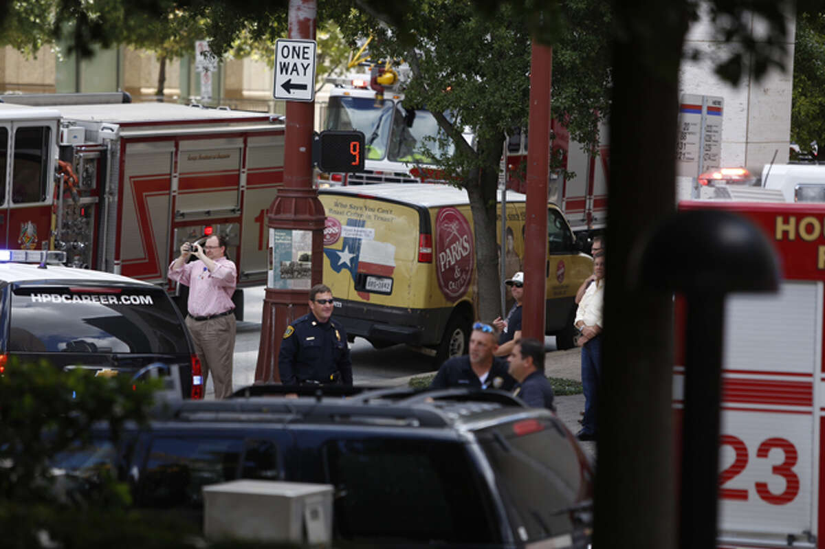 Houston firefighters respond to an alarm just before noon Thursday at the Alley Theater in downtown Houston.
