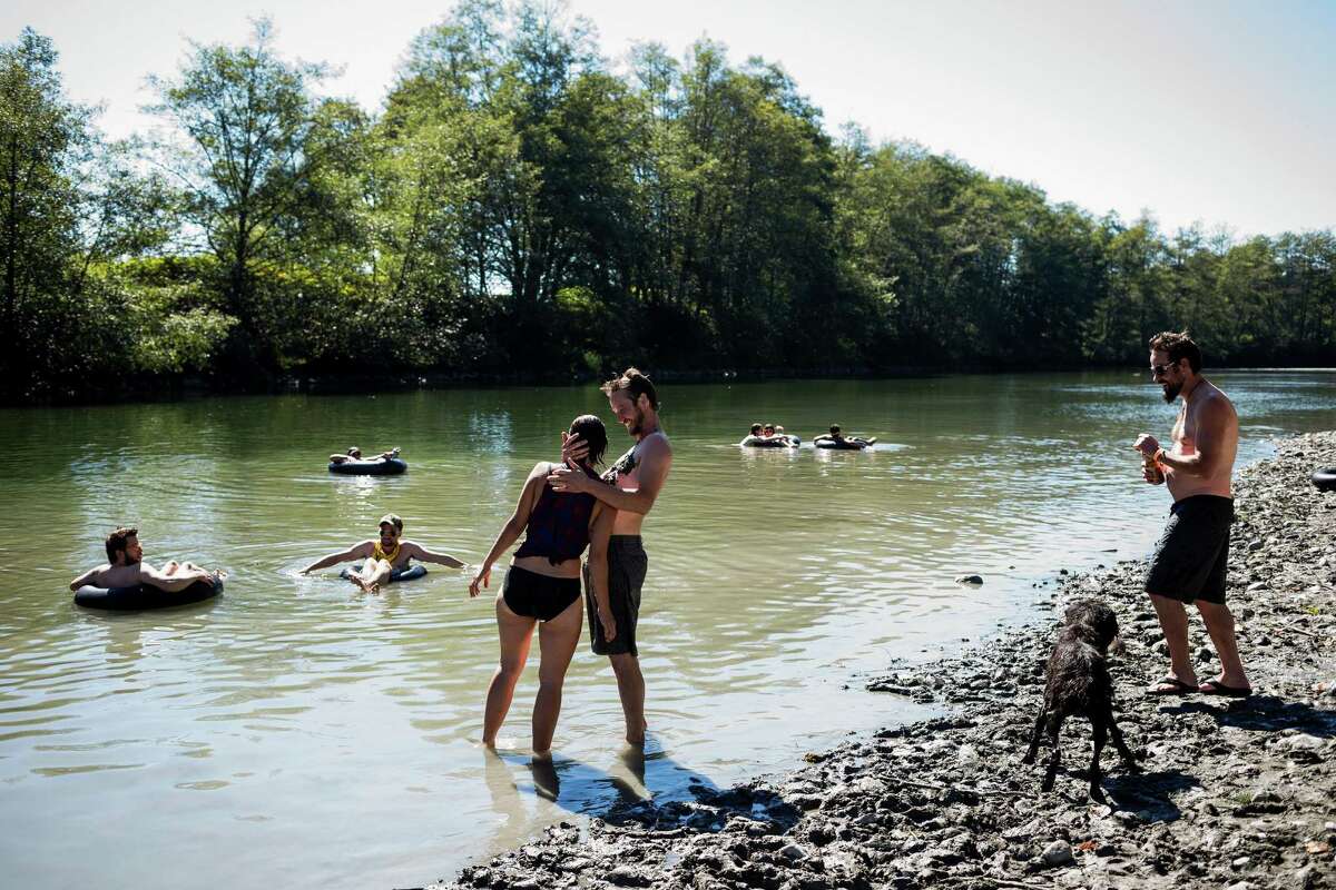 Campers relax by the river at the eighth annual Lo-Fi Festival Sunday, Sept. 7, 2014,  at The Smoke Farm in Arlington.