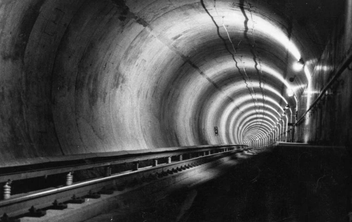 A file photo of the BART Trans-Bay tube tunnel - "M2 track - third rail on left, escape platform on right, radio antennae overhead.