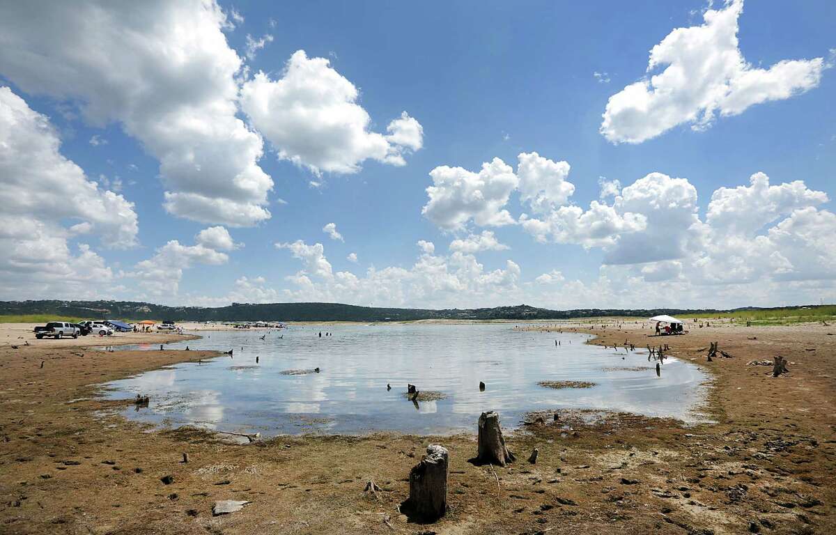 Tree stumps stick out of dried-up Lake Travis last year, one sign of the type of extreme weather that is a hallmark of climate change.