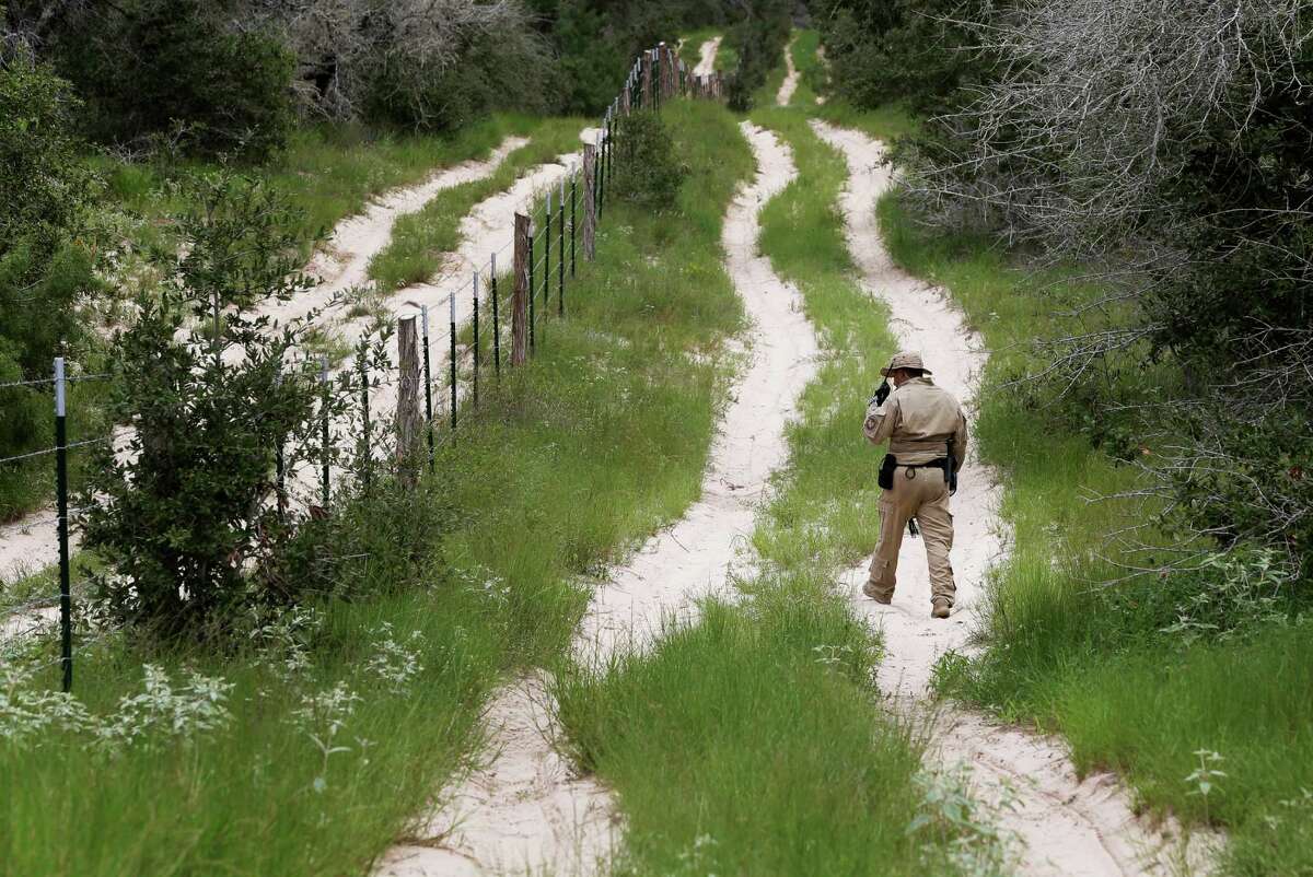 FILE - In this Sept. 5, 2014 file photo, a U.S. Customs and Border Protection Air and Marine agent looks for signs along trail while on patrol near the Texas-Mexico border near McAllen, Texas. President Barack Obama, who has postponed until after Election Day his plan for executive actions that could shield millions of immigrants from deportation, is already on pace this year to deport the fewest number of immigrants since at least 2007, according to a new analysis of Homeland Security Department figures by The Associated Press. (AP Photo/Eric Gay, File)