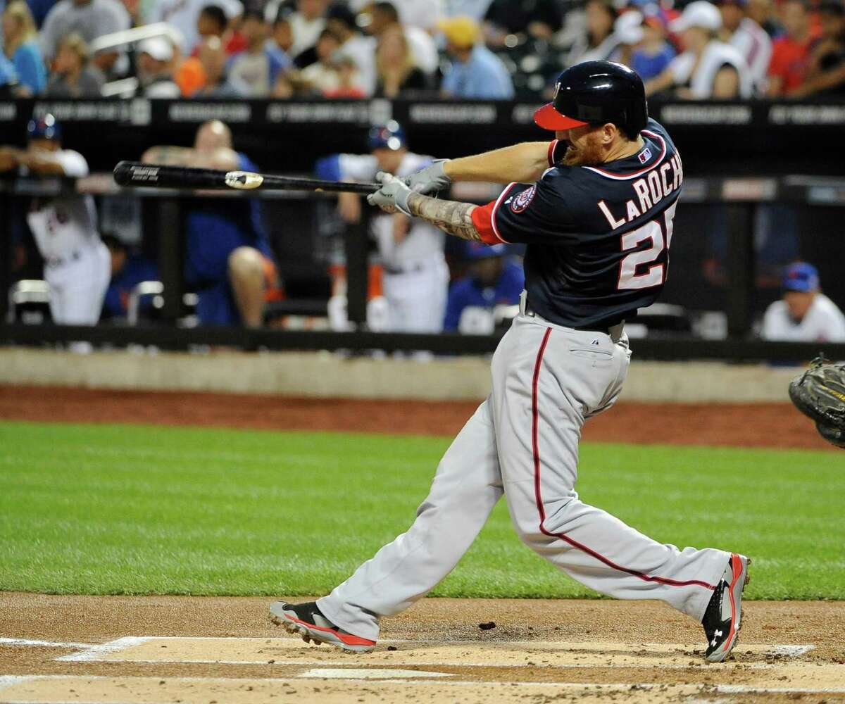 Washington Nationals' Adam LaRoche hits a two-run home run off of New York Mets starting pitcher Bartolo Colon in the first inning of a baseball game Thursday, Sept. 11, 2014, in New York. (AP Photo/Kathy Kmonicek) ORG XMIT: NYM107